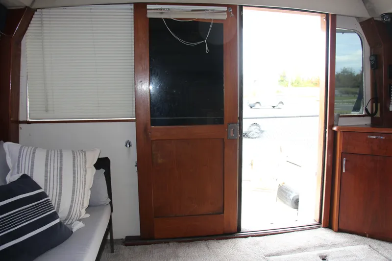 Slide: The Image of Interior of 1989 Ocean Yachts 35 Super Sport with wooden door and cozy seating. - 12