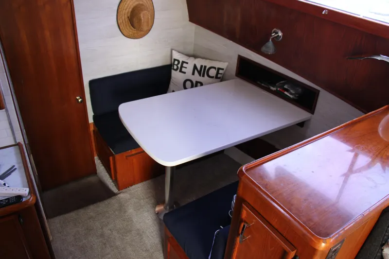 Slide: The Image of 1989 Ocean Yachts 35 Super Sport interior with dining area and wooden cabinetry. - 15