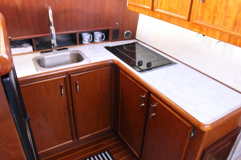 Slide: The Image of 1989 Ocean Yachts 35 Super Sport kitchen with wooden cabinets and modern appliances. - 18