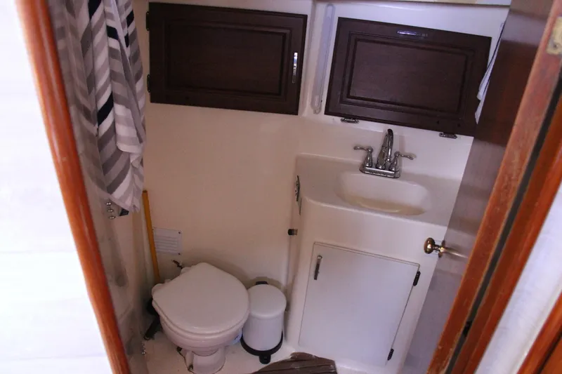 Slide: The Image of Bathroom interior of 1989 Ocean Yachts 35 Super Sport with sink and toilet. - 21