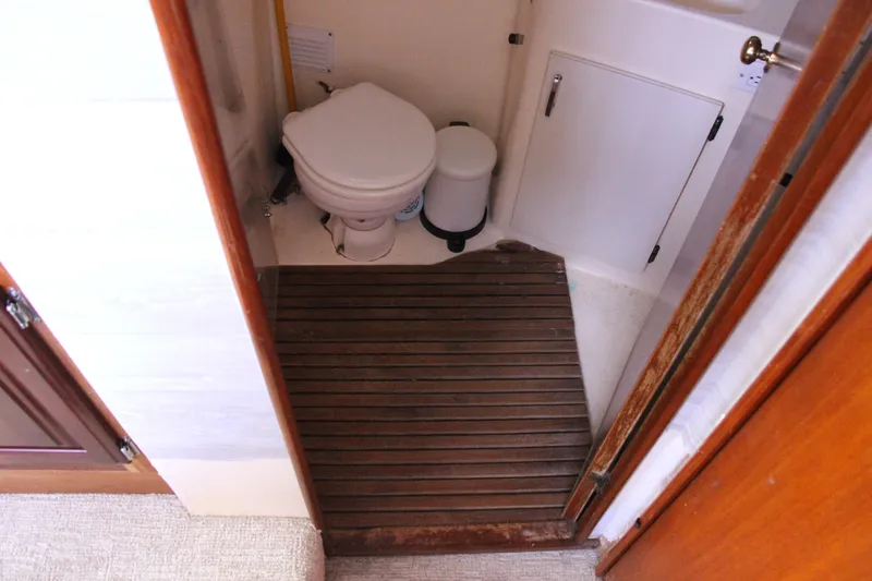 Slide: The Image of 1989 Ocean Yachts 35 Super Sport bathroom with wooden floor and compact toilet. - 22