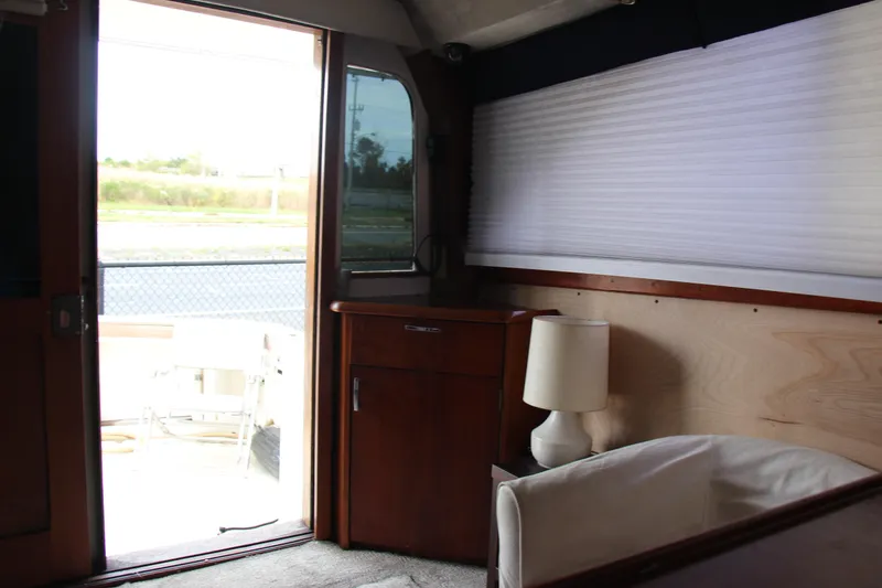 Slide: The Image of Interior of 1989 Ocean Yachts 35 Super Sport with wooden cabinetry and a lamp. - 23