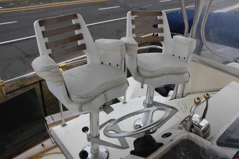 Slide: The Image of Captain's chairs on 1989 Ocean Yachts 35 Super Sport boat, featuring helm controls. - 24