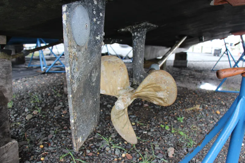 Slide: The Image of 1989 Ocean Yachts 35 Super Sport propeller and rudder detail on gravel. - 25