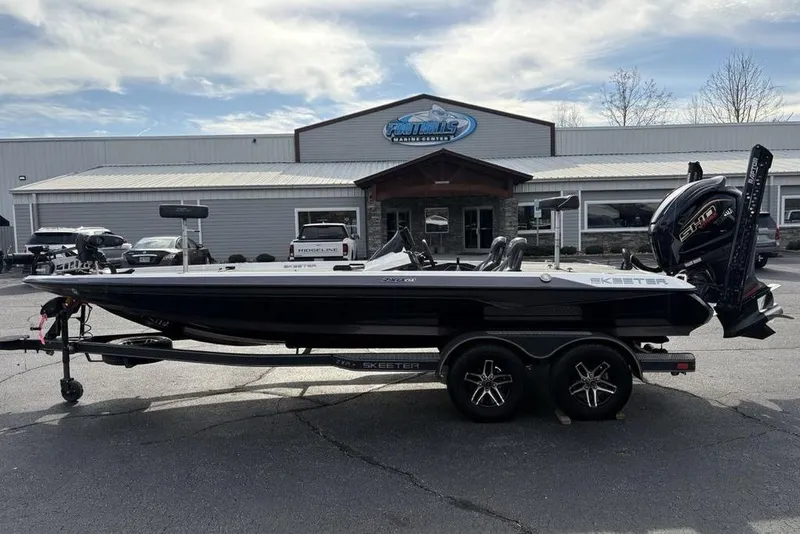 The Image of 2023 Skeeter ZXR21 boat on trailer outside a dealership, showcasing sleek design and powerful engine. - 0