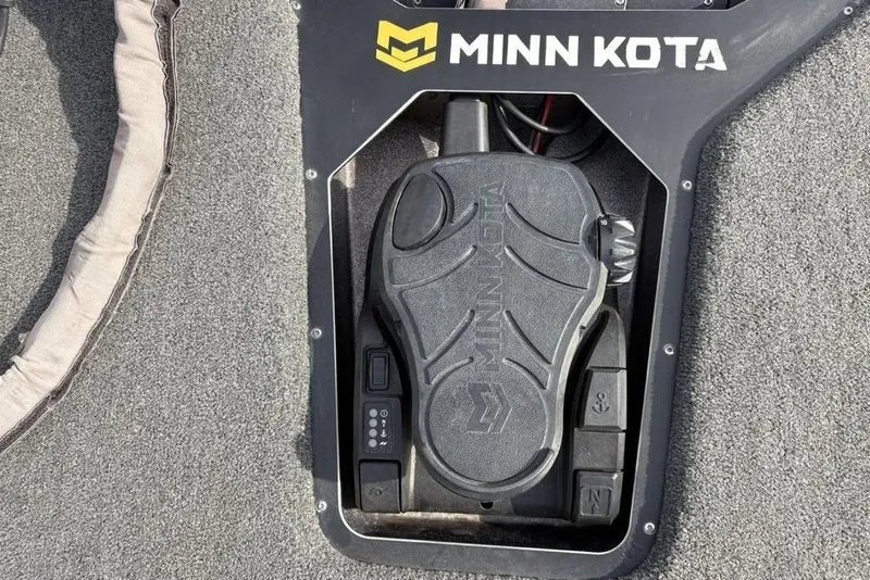 Slide: The Image of Minn Kota foot pedal on 2023 Skeeter ZXR21 boat, featuring control buttons and textured surface. - 10