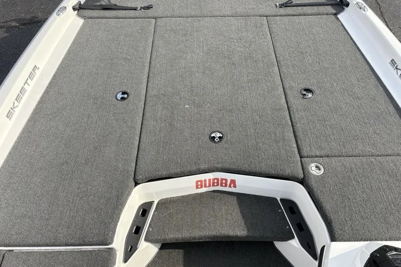 Slide: The Image of 2023 Skeeter ZXR21 boat deck with gray carpet and "Bubba" branding. - 13