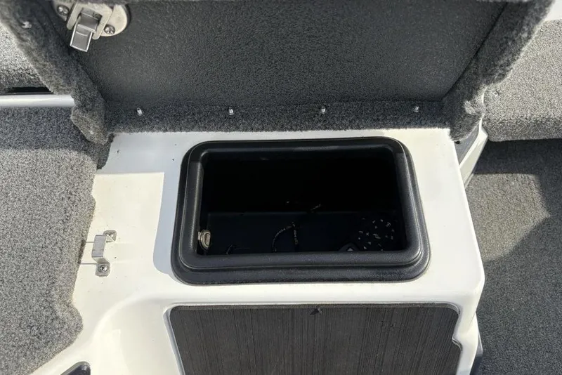 Slide: The Image of 2023 Skeeter ZXR21 boat storage compartment with open lid, showcasing interior space. - 18