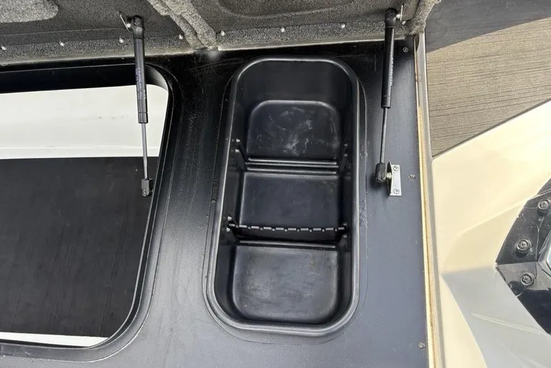 Slide: The Image of 2023 Skeeter ZXR21 boat storage compartment with hydraulic lift supports. - 19