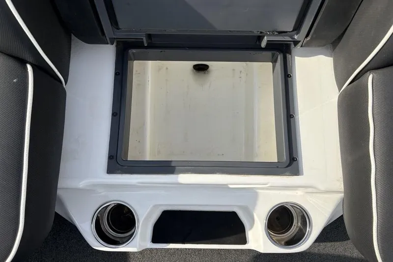Slide: The Image of 2023 Skeeter ZXR21 boat storage compartment with cup holders and black seating. - 20