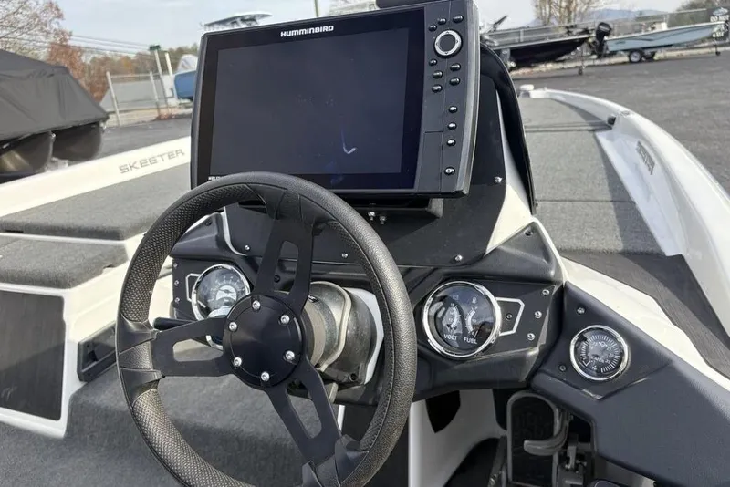 Slide: The Image of 2023 Skeeter ZXR21 boat dashboard with steering wheel and Humminbird display. - 31