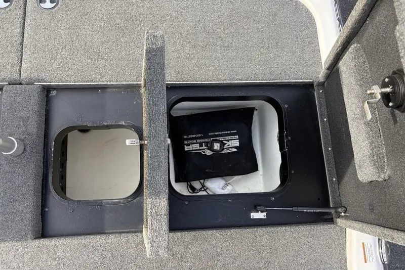 Slide: The Image of 2023 Skeeter ZXR21 boat storage compartments with open hatches, showcasing interior space. - 33