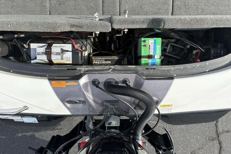 Slide: The Image of 2023 Skeeter ZXR21 boat battery compartment with precision charger and wiring. - 34