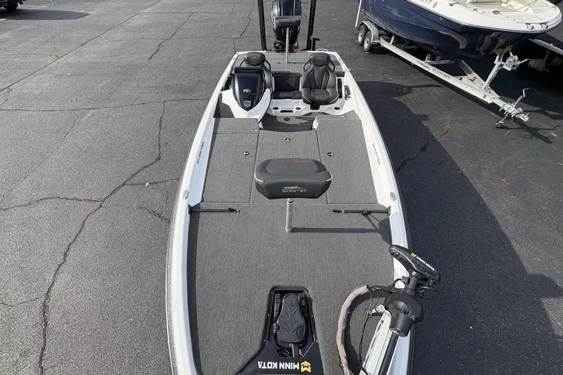 Slide: The Image of 2023 Skeeter ZXR21 fishing boat with dual seats and trolling motor on display. - 37