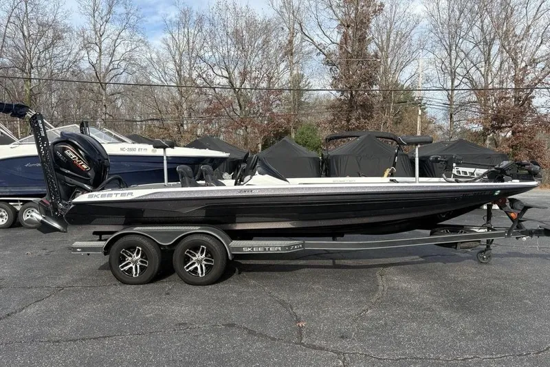 Slide: The Image of 2023 Skeeter ZXR21 boat on trailer, parked outdoors, side view. - 4