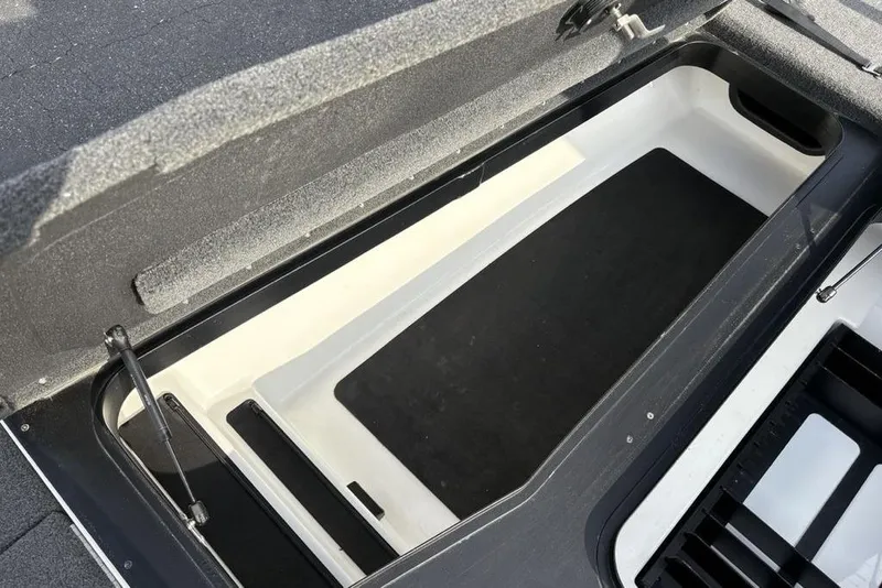 Slide: The Image of 2023 Skeeter ZXR21 boat storage compartment with open lid and hydraulic support. - 9