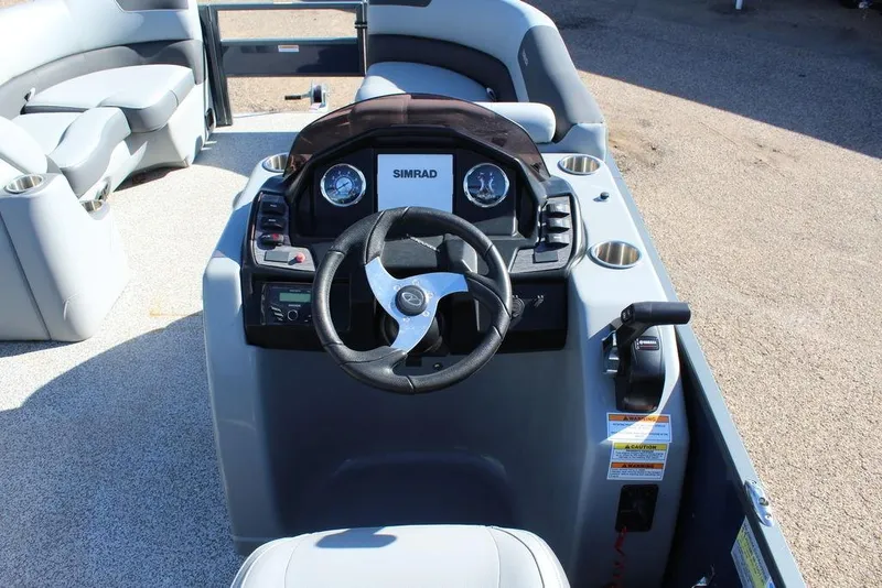 Slide: The Image of 2022 Veranda VF22F2 Bi-Toon boat dashboard with steering wheel and controls. - 12