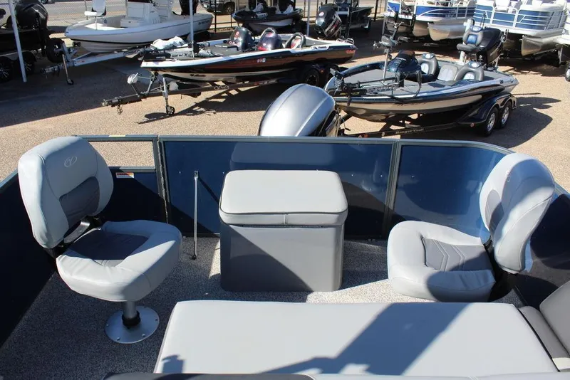 Slide: The Image of 2022 Veranda VF22F2 Bi-Toon interior with seating and storage, surrounded by boats. - 14