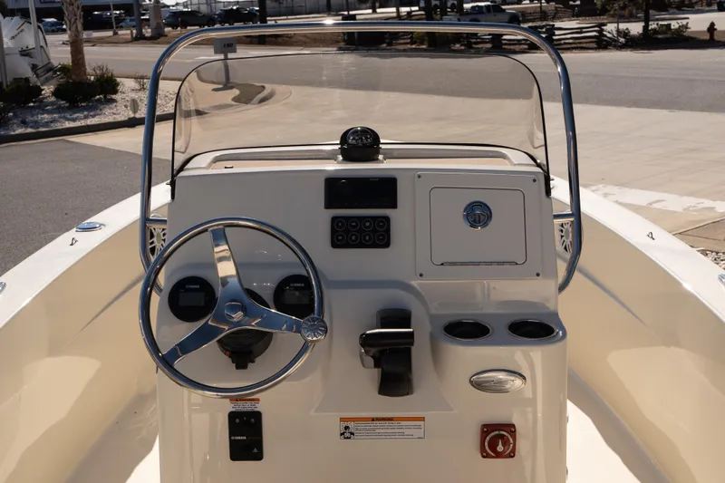 Slide: The Image of 2026 Scout 188 Sportfish boat console with steering wheel and controls. - 9