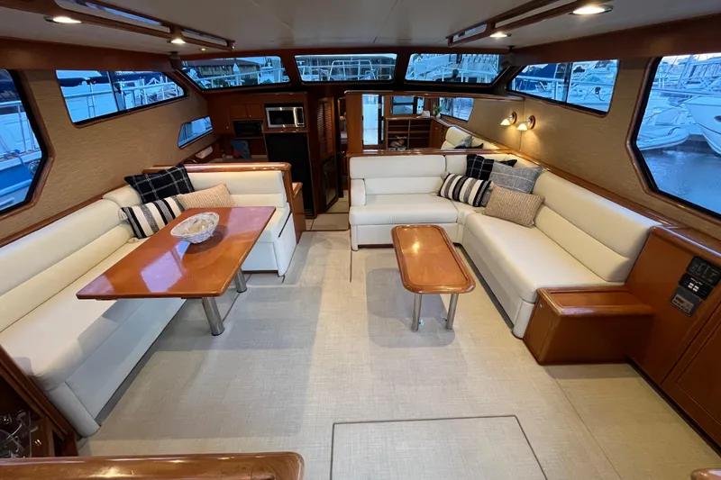 Slide: The Image of Luxurious interior of a 2001 Mikelson Luxury Sportfisher yacht with elegant seating and tables. - 10