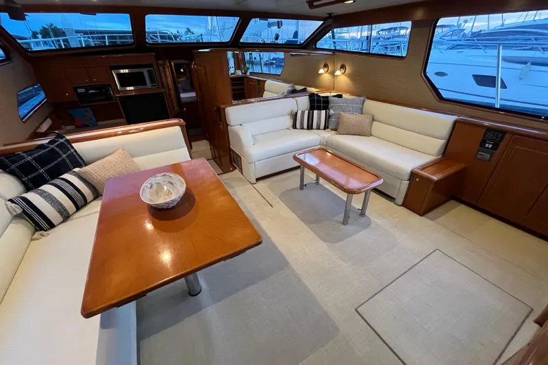Slide: The Image of Luxurious interior of 2001 Mikelson Luxury Sportfisher yacht with elegant seating and wooden accents. - 11