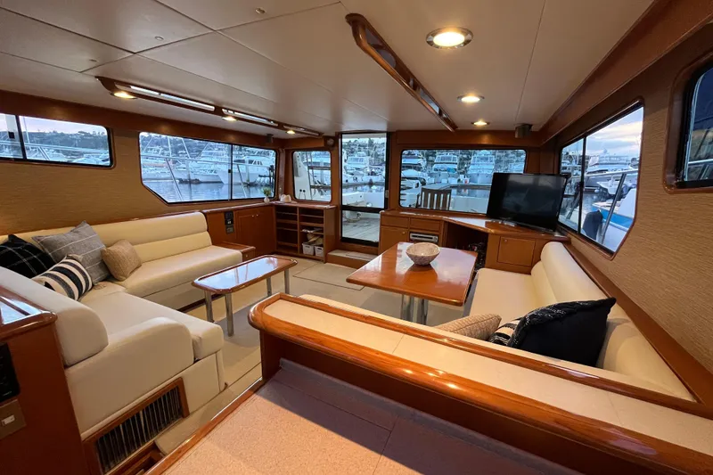 Slide: The Image of Luxurious interior of a 2001 Mikelson Luxury Sportfisher yacht with elegant seating and marina view. - 17