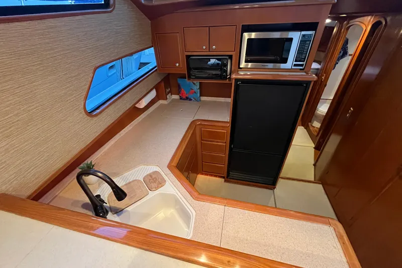 Slide: The Image of Interior of 2001 Mikelson Luxury Sportfisher yacht kitchen with modern appliances. - 19