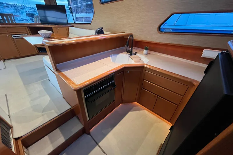 Slide: The Image of Interior of 2001 Mikelson Luxury Sportfisher yacht with modern kitchen and seating area. - 20
