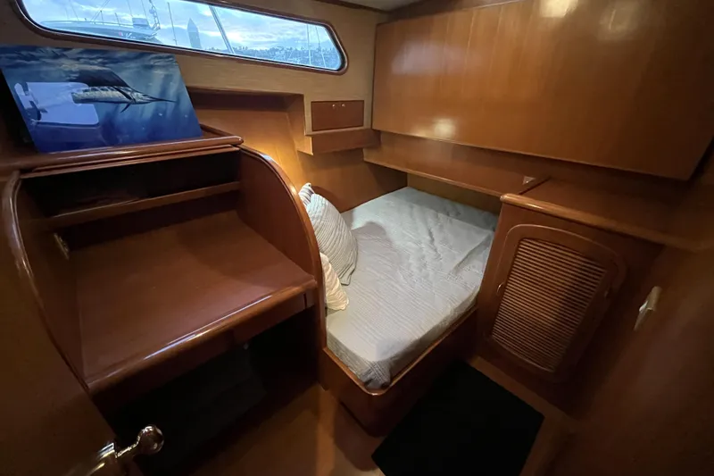 Slide: The Image of 2001 Mikelson Luxury Sportfisher cabin with wooden interior and cozy bed. - 25