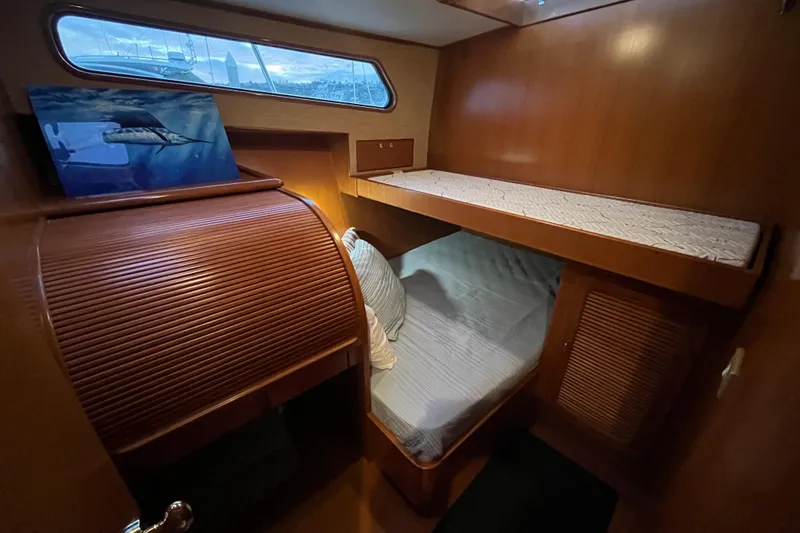 Slide: The Image of 2001 Mikelson Luxury Sportfisher cabin with wooden interior and bunk beds. - 26