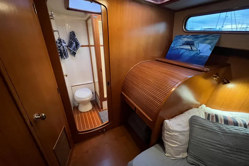 Slide: The Image of 2001 Mikelson Luxury Sportfisher cabin with wooden interior and private bathroom. - 27