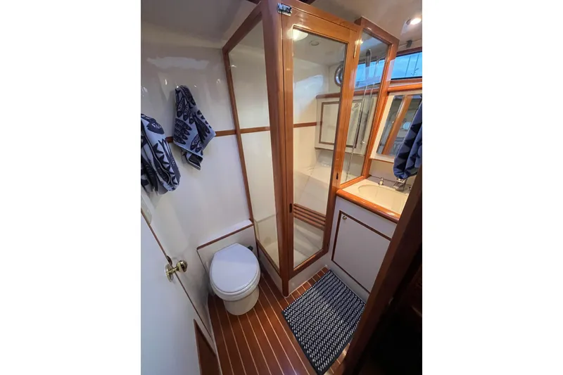 Slide: The Image of Luxurious bathroom in 2001 Mikelson Luxury Sportfisher yacht with shower and wooden accents. - 28