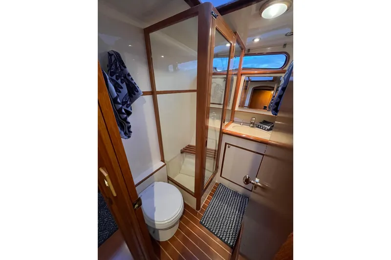 Slide: The Image of Luxurious bathroom interior of 2001 Mikelson Luxury Sportfisher yacht with wood accents. - 29