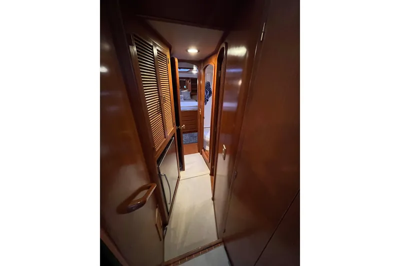 Slide: The Image of Interior hallway of 2001 Mikelson Luxury Sportfisher yacht with wooden finishes. - 30