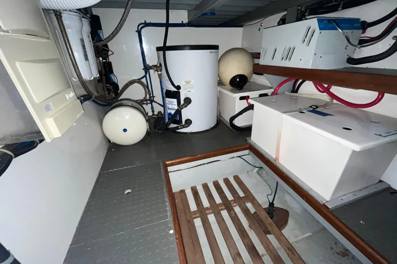 Slide: The Image of Engine room of 2001 Mikelson Luxury Sportfisher with equipment and storage. - 32