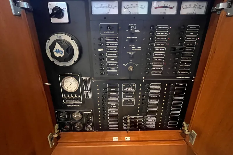 Slide: The Image of Electrical control panel of a 2001 Mikelson Luxury Sportfisher yacht, featuring various switches and gauges. - 33