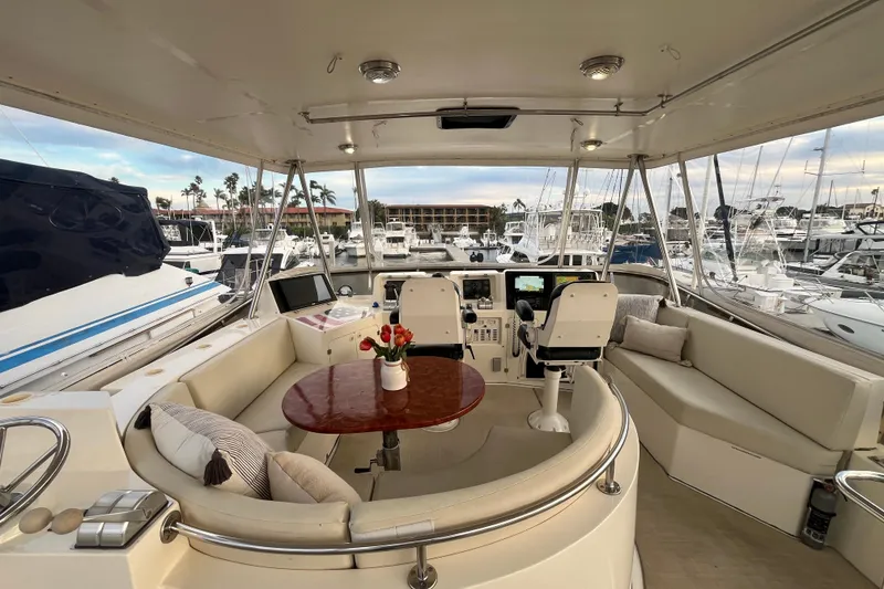 Slide: The Image of Luxurious 2001 Mikelson Sportfisher yacht interior with helm, seating, and marina view. - 34