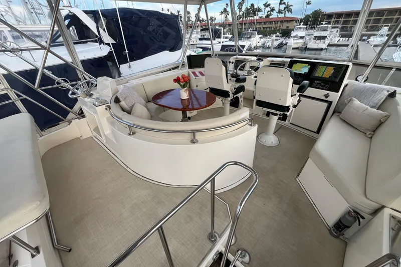 Slide: The Image of 2001 Mikelson Luxury Sportfisher interior with helm, seating, and navigation equipment in marina setting. - 36