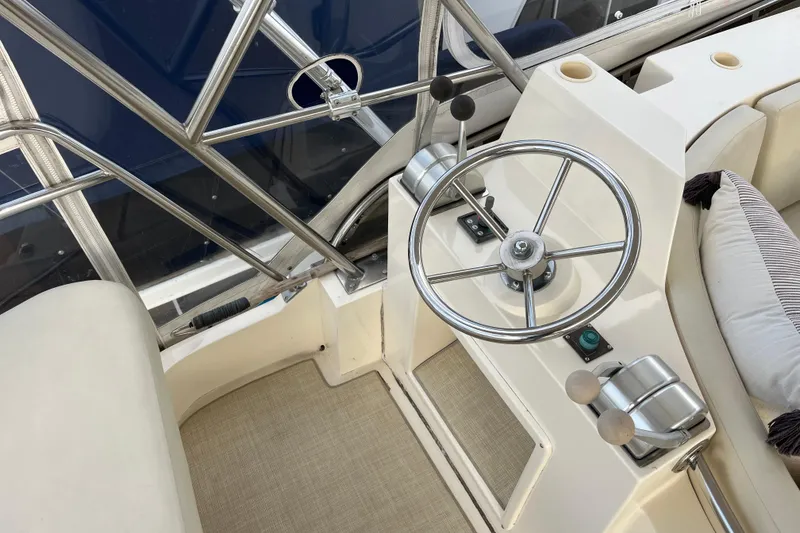 Slide: The Image of 2001 Mikelson Luxury Sportfisher helm with steering wheel and controls. - 39