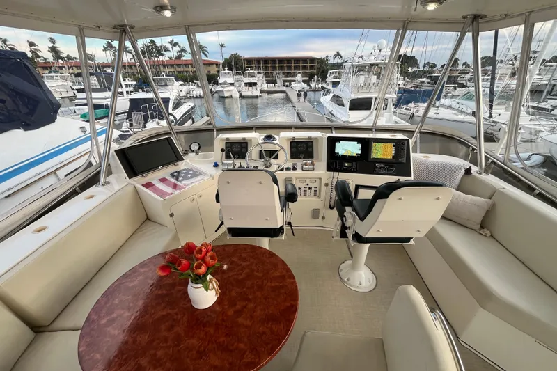 Slide: The Image of Luxurious 2001 Mikelson Sportfisher yacht interior with helm, seating, and marina view. - 40
