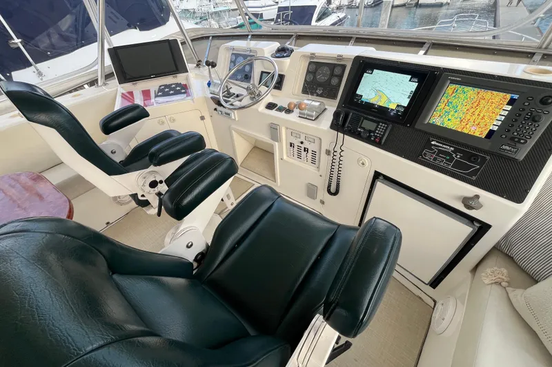 Slide: The Image of 2001 Mikelson Luxury Sportfisher helm with navigation screens and leather seating. - 41