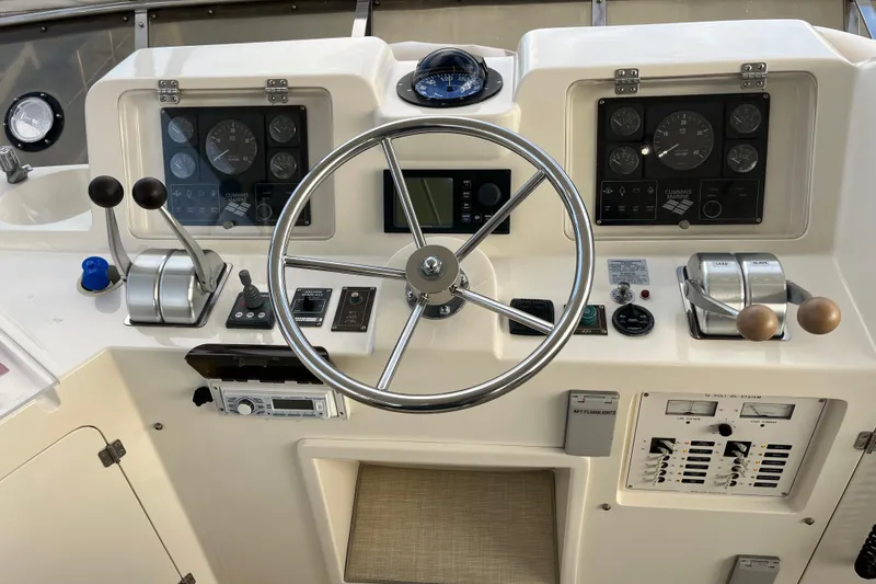 Slide: The Image of 2001 Mikelson Luxury Sportfisher helm with steering wheel and control panels. - 43