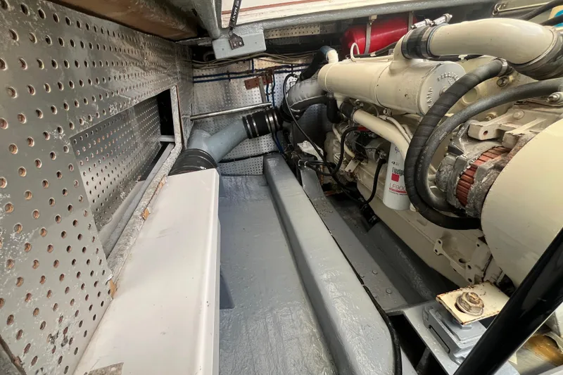 Slide: The Image of Engine room of a 2001 Mikelson Luxury Sportfisher, showcasing detailed mechanical components. - 47