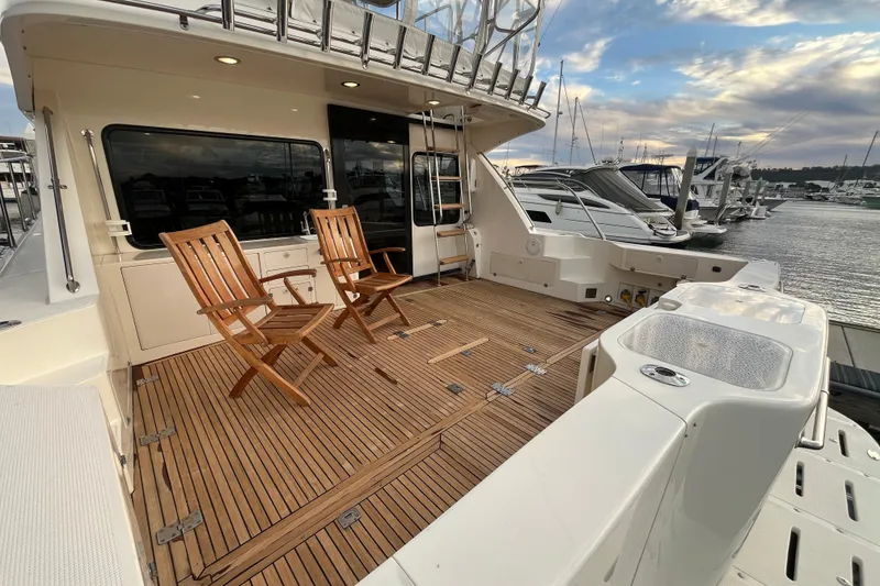 Slide: The Image of 2001 Mikelson Luxury Sportfisher yacht with wooden deck and chairs at marina. - 5