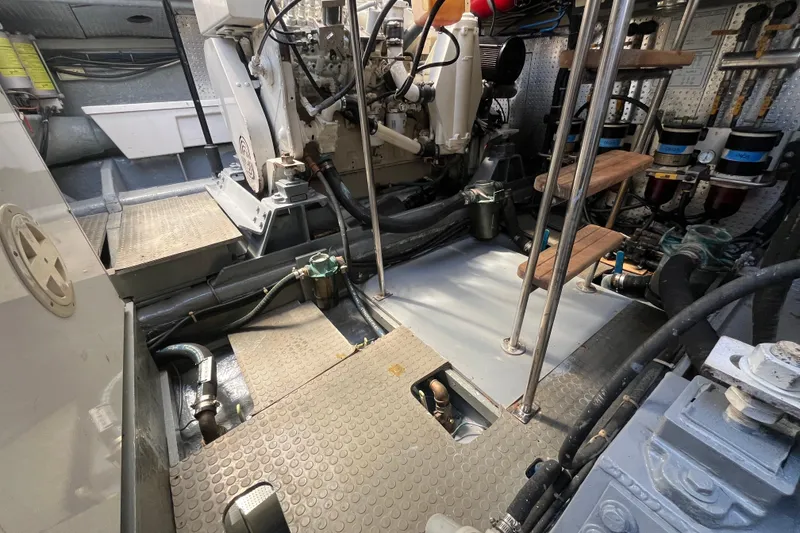 Slide: The Image of Engine room of a 2001 Mikelson Luxury Sportfisher, showcasing mechanical components and equipment. - 51