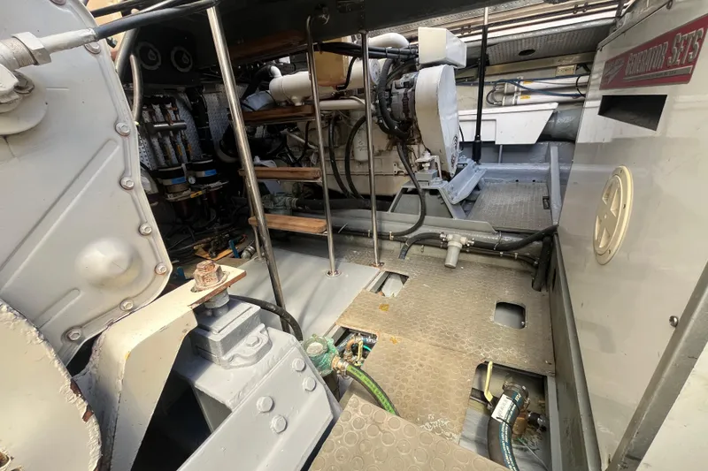 Slide: The Image of Engine room of a 2001 Mikelson Luxury Sportfisher, showcasing mechanical components and equipment. - 52