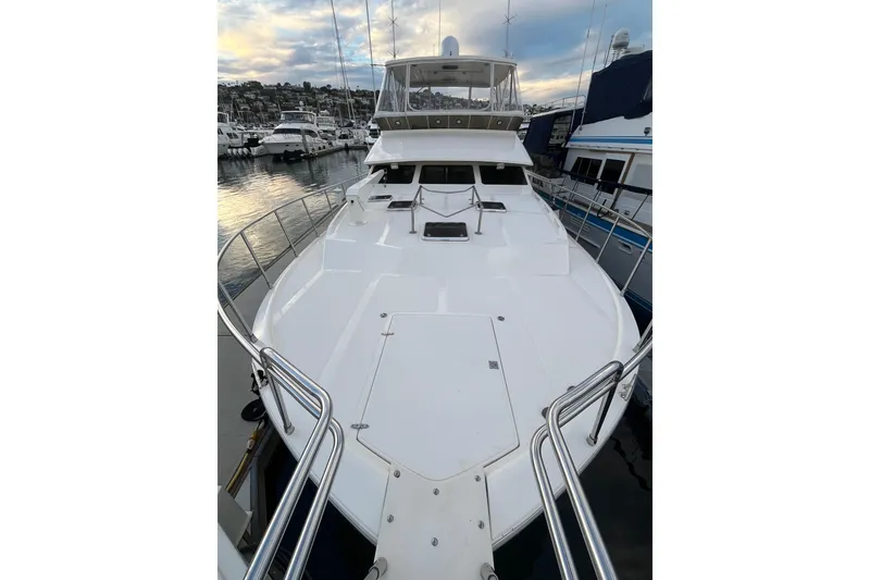Slide: The Image of 2001 Mikelson Luxury Sportfisher yacht docked at marina, showcasing spacious deck. - 55