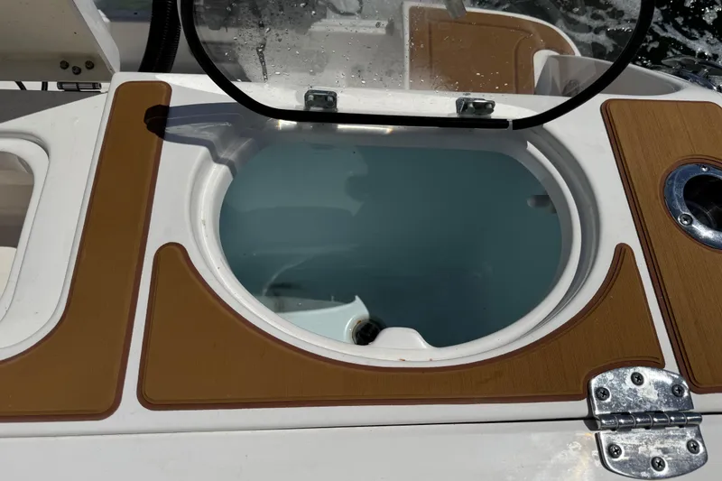 Slide: The Image of Livewell on 2021 Robalo R242 Center Console boat, open lid, teak accents. - 11
