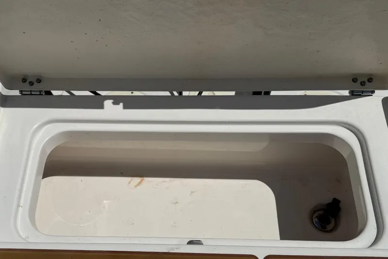 Slide: The Image of Open storage compartment on 2021 Robalo R242 Center Console boat. - 12