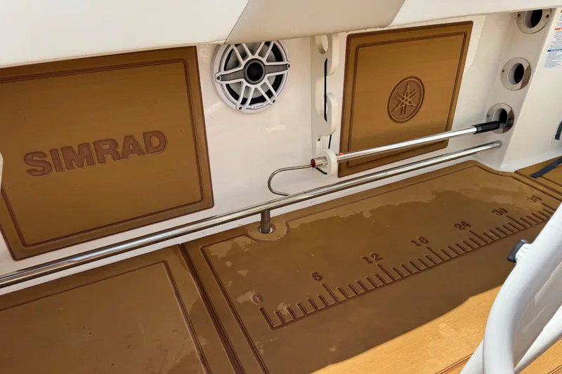 Slide: The Image of 2021 Robalo R242 Center Console boat deck with Simrad and Yamaha features. - 14